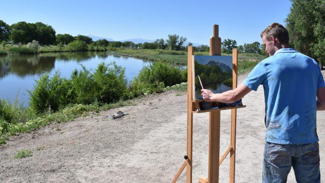 Student painting a landscape near the Rio Grande